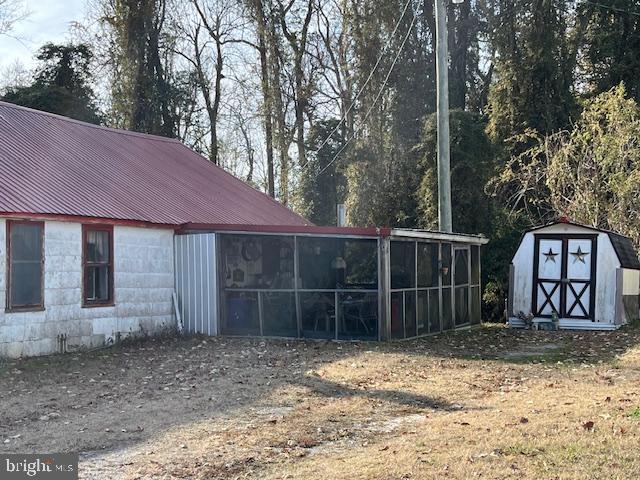 view of outbuilding featuring a sunroom