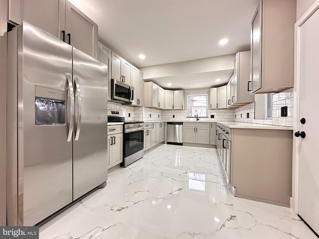 kitchen featuring decorative backsplash, sink, and stainless steel appliances