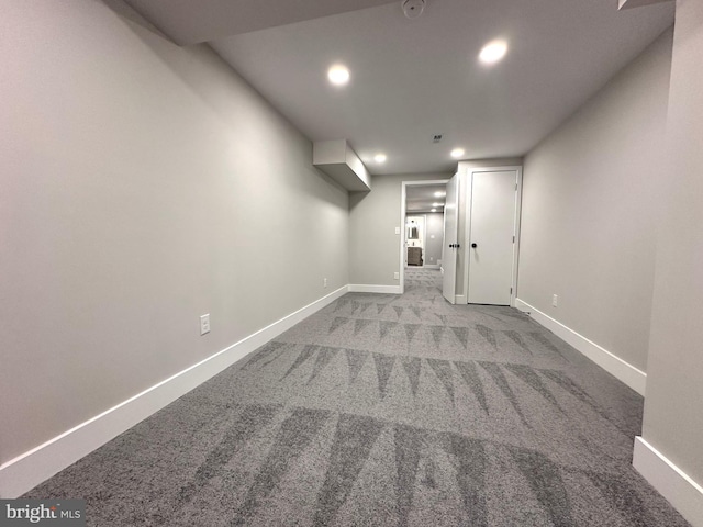 basement featuring light carpet