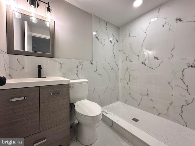 bathroom featuring a shower, toilet, decorative backsplash, vanity, and tile walls