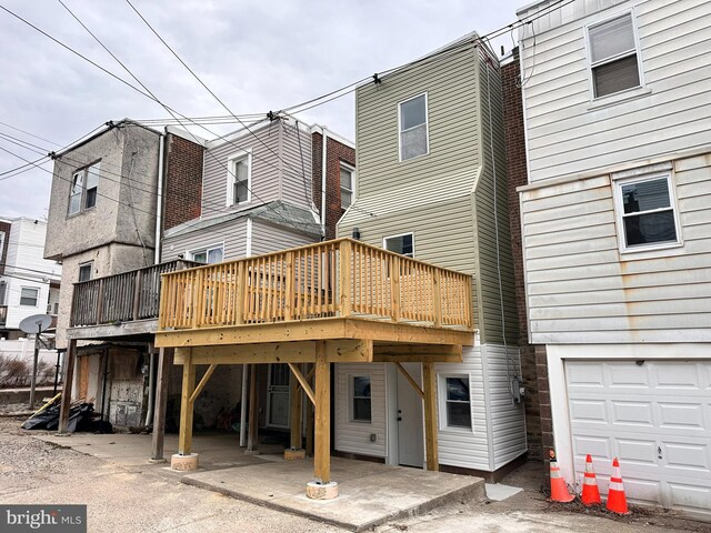 back of property featuring a wooden deck