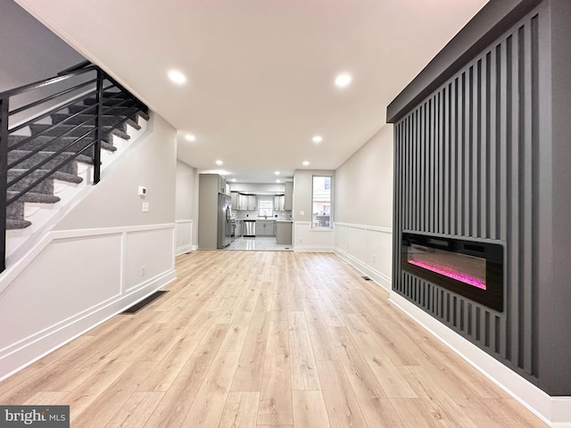 unfurnished living room with light wood-type flooring