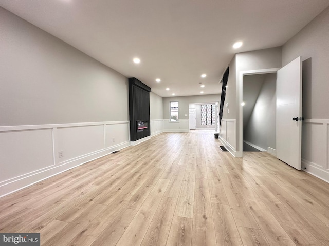 unfurnished living room with light wood-type flooring