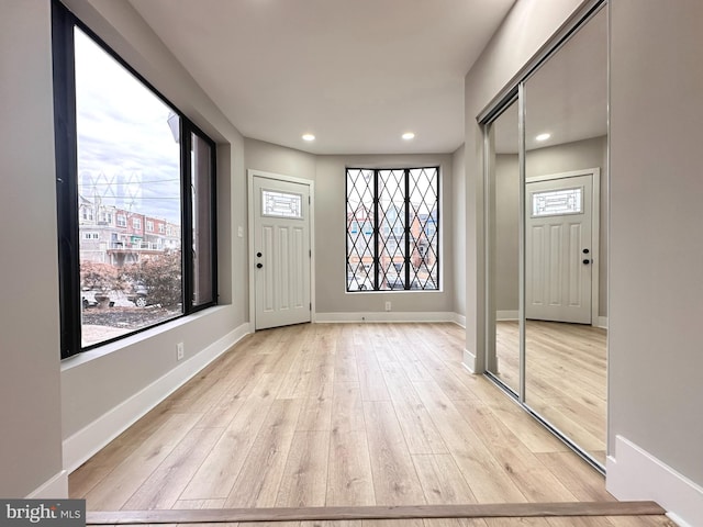 foyer entrance with light wood-type flooring