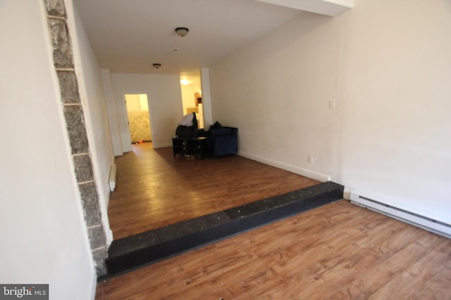 hallway with hardwood / wood-style floors and a baseboard heating unit