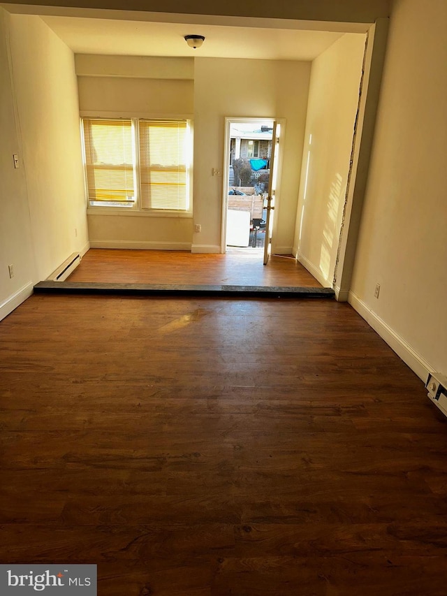 spare room with dark hardwood / wood-style flooring