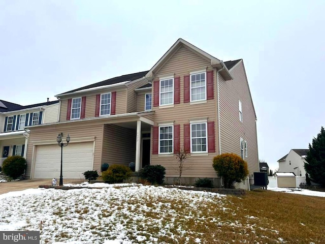 view of front of house featuring a garage and cooling unit