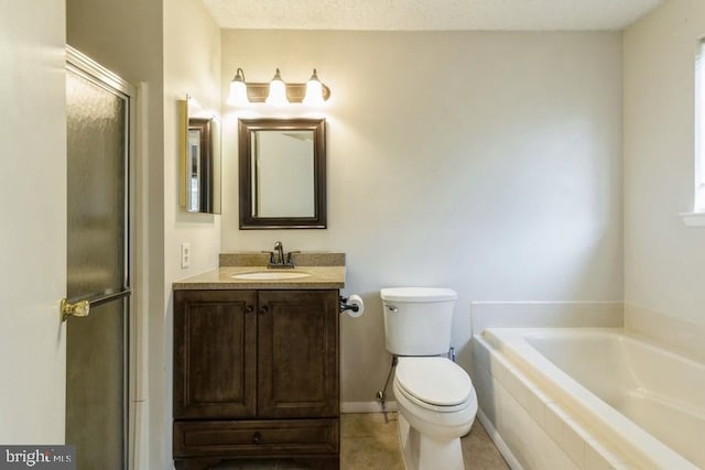 bathroom featuring toilet, a textured ceiling, tile patterned floors, tiled tub, and vanity