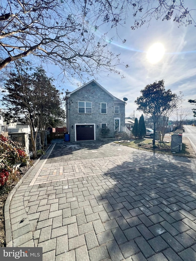 rear view of house featuring a garage