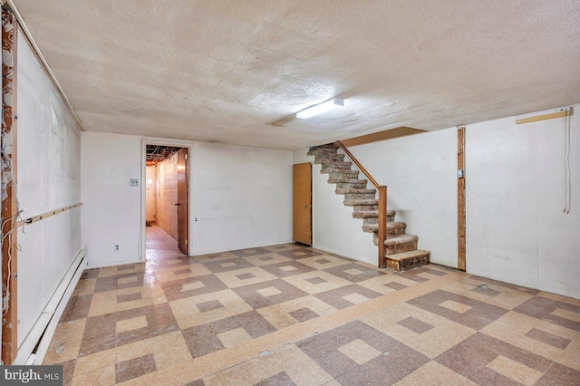 basement featuring a textured ceiling and a baseboard radiator