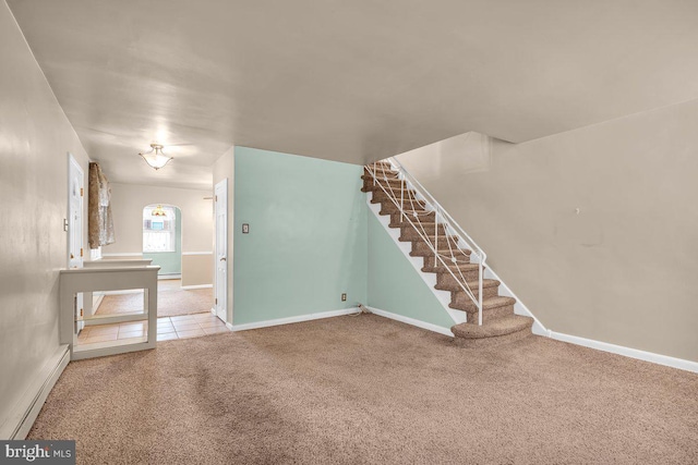 spare room featuring carpet flooring and baseboard heating