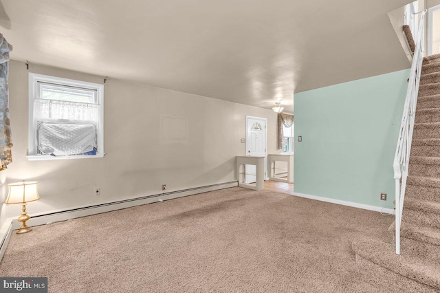 unfurnished room featuring a baseboard radiator and carpet flooring