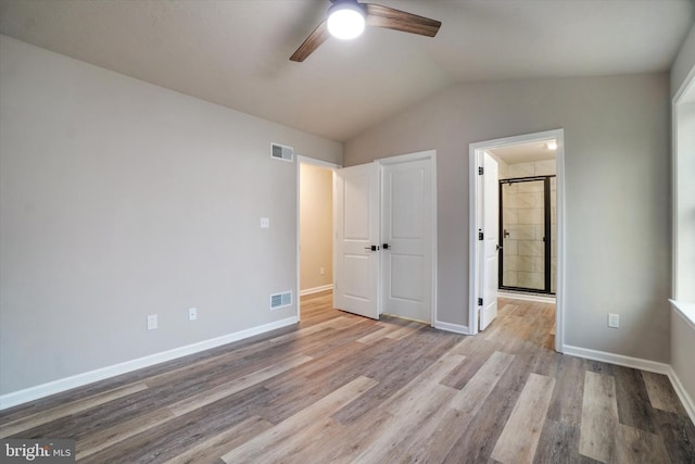 unfurnished bedroom featuring ceiling fan, vaulted ceiling, and light wood-type flooring