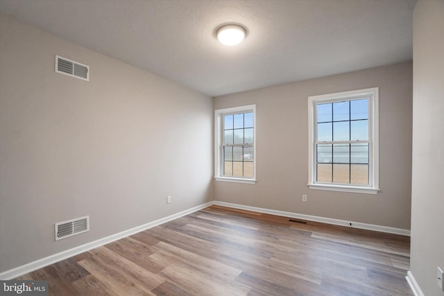 empty room with hardwood / wood-style floors