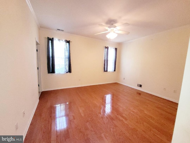 unfurnished room with ceiling fan and hardwood / wood-style flooring