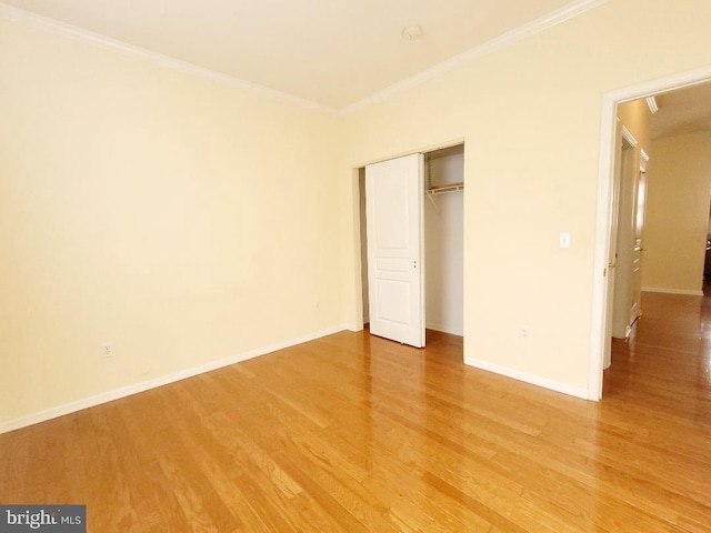 unfurnished bedroom featuring ornamental molding and hardwood / wood-style flooring