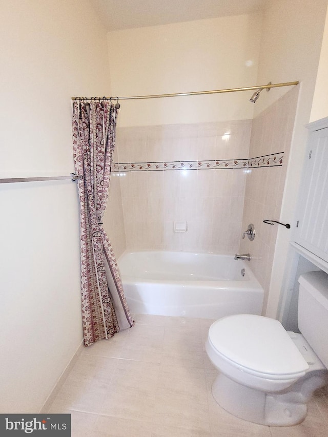 bathroom with toilet, tile patterned floors, and shower / tub combo with curtain