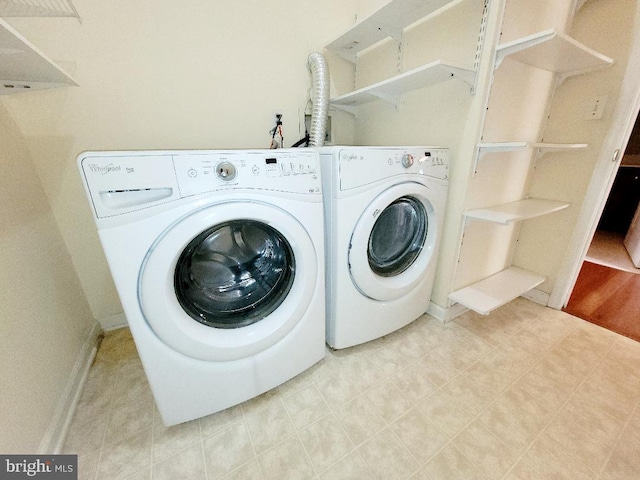 laundry room featuring washing machine and clothes dryer