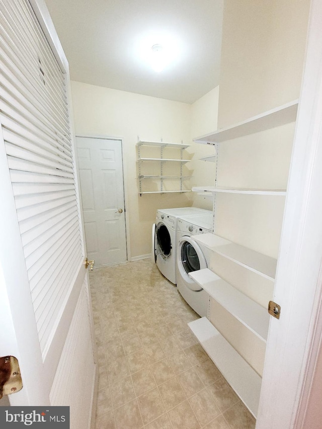 clothes washing area with washing machine and dryer