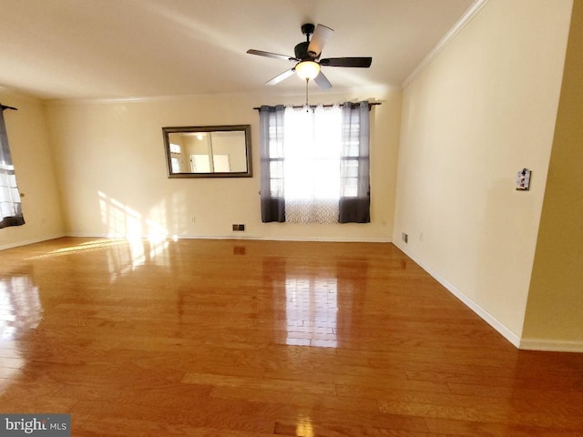 unfurnished room with ceiling fan, ornamental molding, and hardwood / wood-style flooring