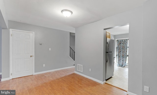 spare room featuring light hardwood / wood-style flooring