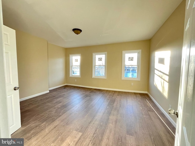 spare room with wood-type flooring