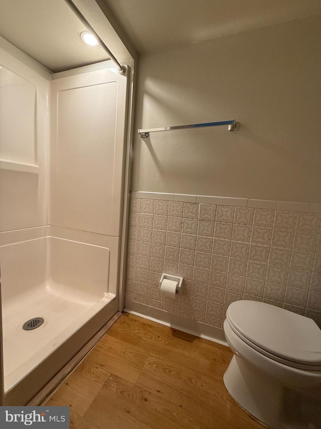 bathroom featuring wood-type flooring and toilet