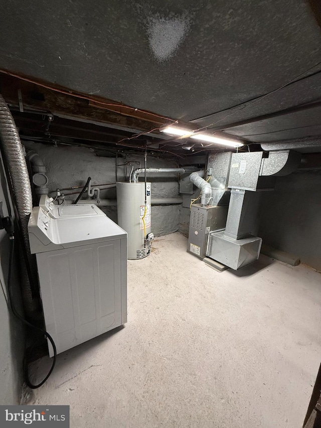 basement featuring heating unit, gas water heater, and washer / clothes dryer