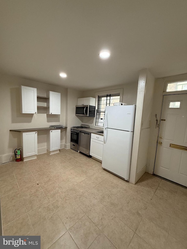 kitchen featuring white cabinets and appliances with stainless steel finishes