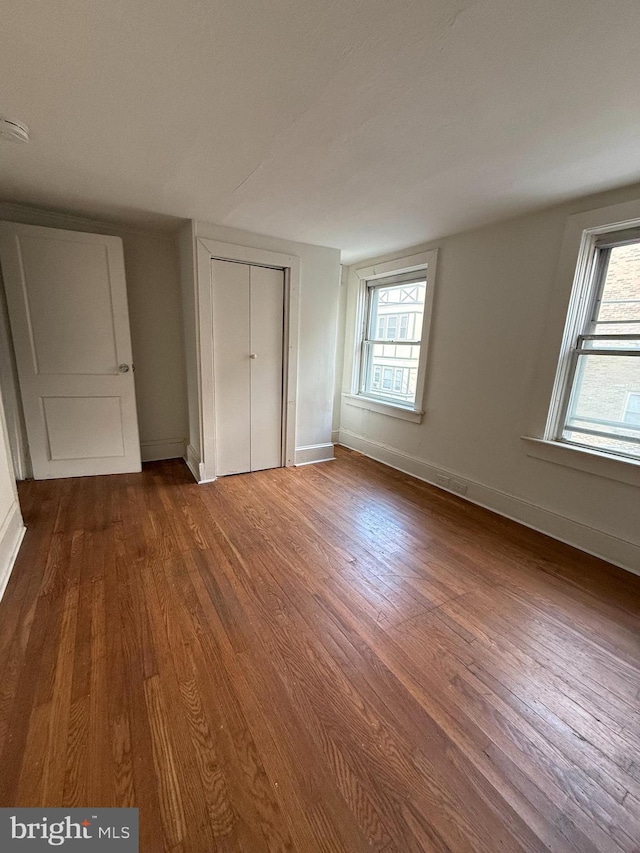 unfurnished bedroom featuring hardwood / wood-style flooring