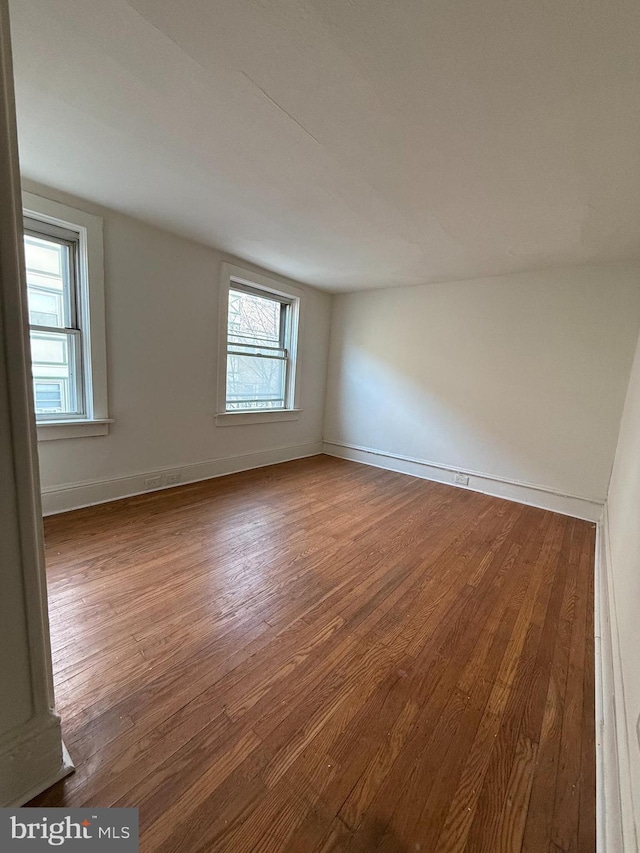 unfurnished room with hardwood / wood-style floors