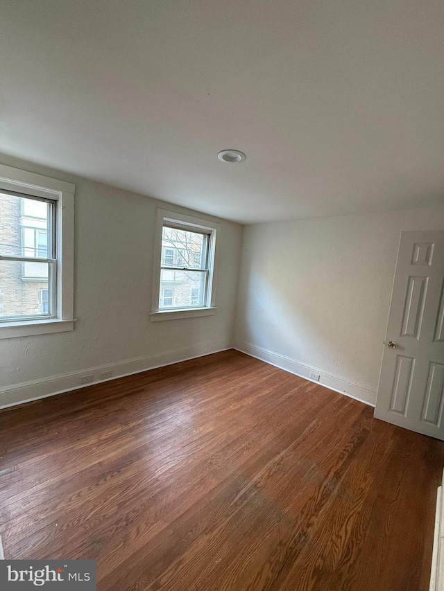 unfurnished room featuring dark hardwood / wood-style flooring