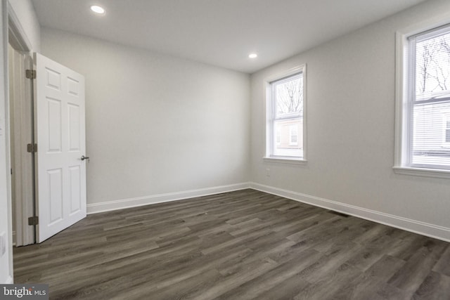 empty room with dark wood-type flooring