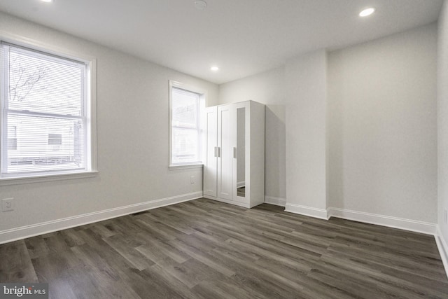 empty room with dark hardwood / wood-style floors