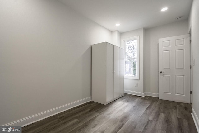 unfurnished bedroom with dark hardwood / wood-style floors