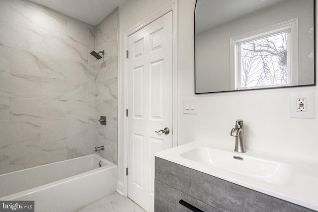 bathroom featuring tiled shower / bath combo and vanity