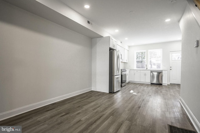 unfurnished living room featuring dark hardwood / wood-style flooring