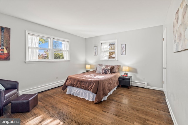 bedroom featuring baseboard heating and dark wood-type flooring