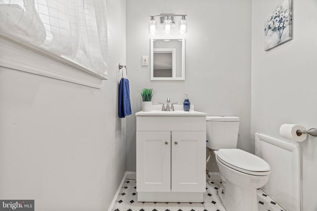 bathroom featuring vanity and toilet