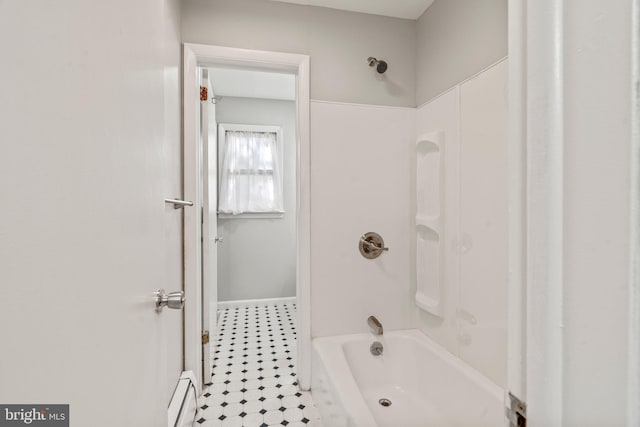 bathroom with shower / tub combination and a baseboard heating unit