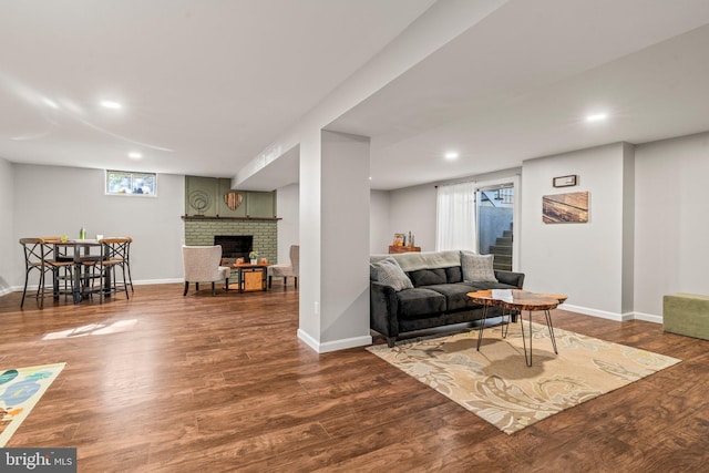 living room with a fireplace and dark hardwood / wood-style floors