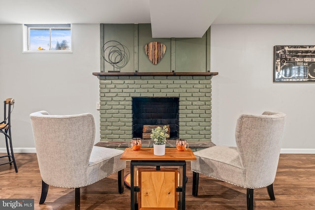 living area with a fireplace and wood-type flooring