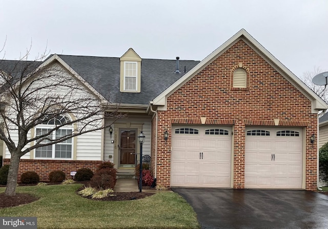 view of front of property with a garage and a front yard