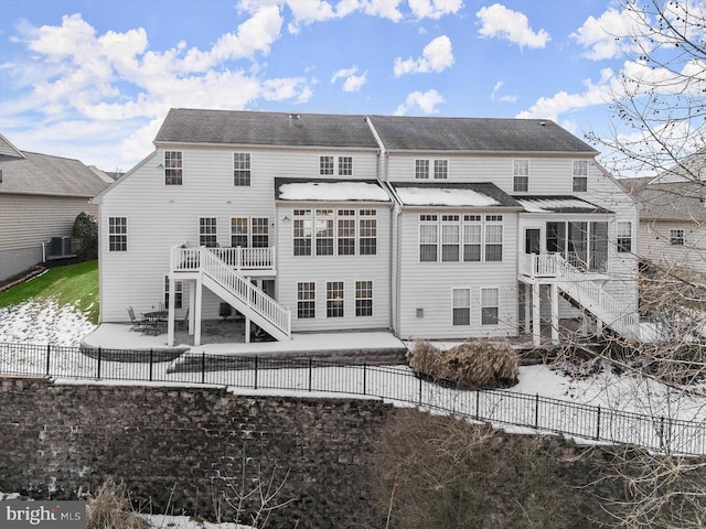 rear view of house with central air condition unit and a deck