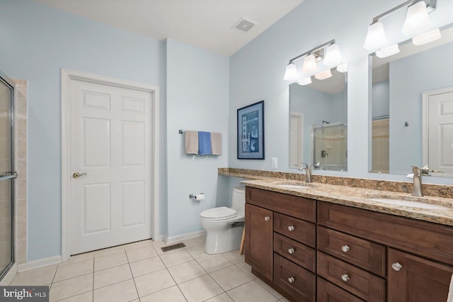 bathroom featuring vanity, toilet, an enclosed shower, and tile patterned flooring