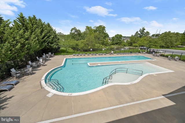 10576 Edwardian Ln Unit 132, New Market, MD 21774 - community pool with fence, a patio, and view of scattered trees