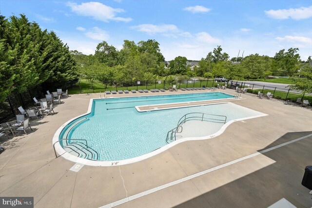 10576 Edwardian Ln Unit 132, New Market, MD 21774 - community pool featuring fence, a patio area, and view of wooded area
