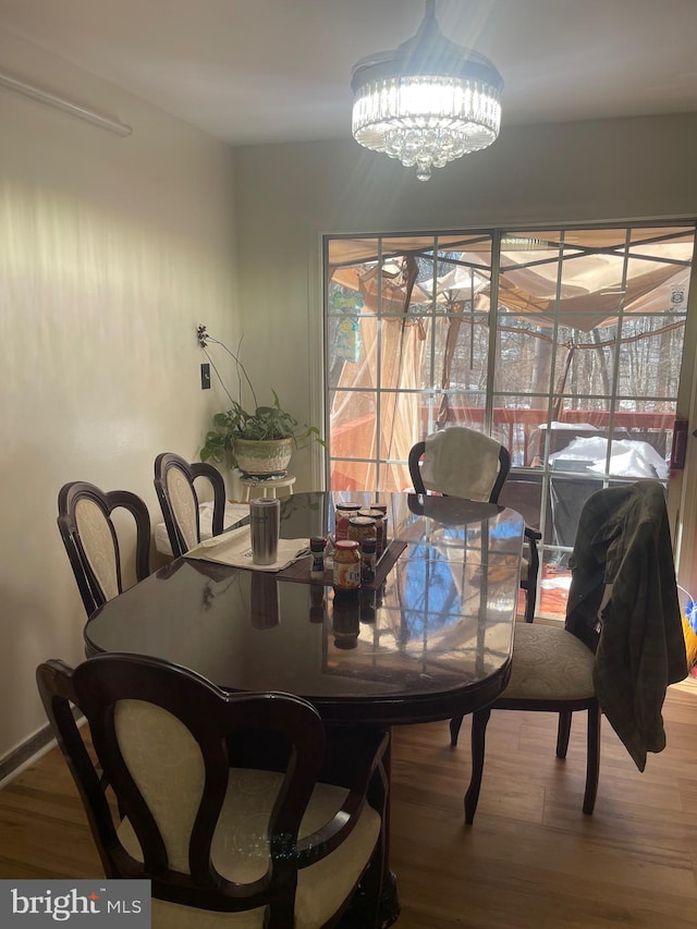 dining room with a notable chandelier and hardwood / wood-style floors