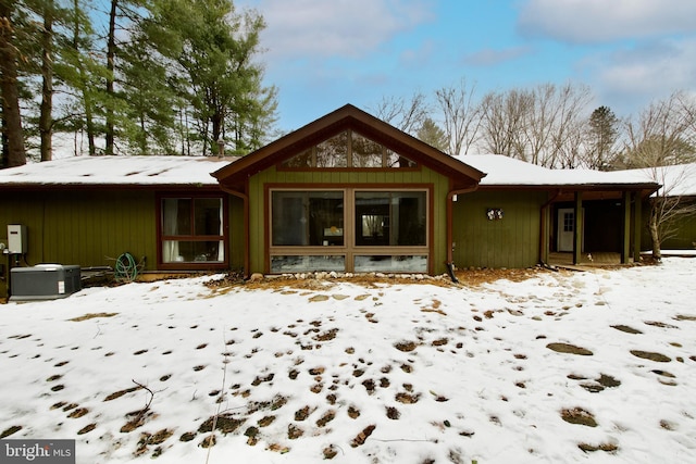 view of snow covered rear of property