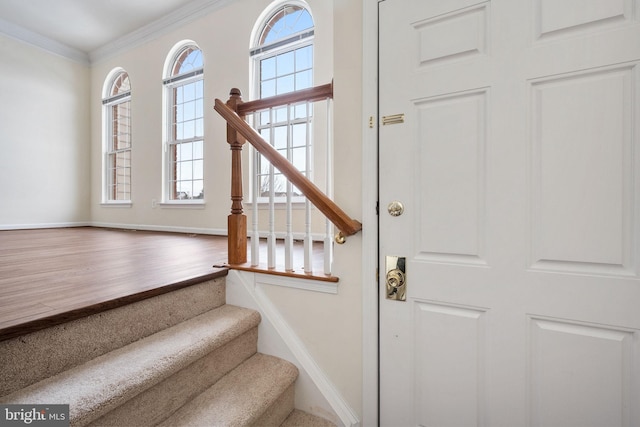 staircase featuring ornamental molding